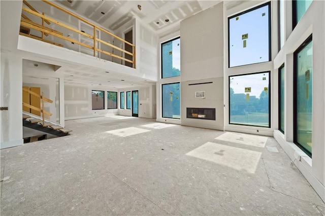 unfurnished living room featuring a high ceiling