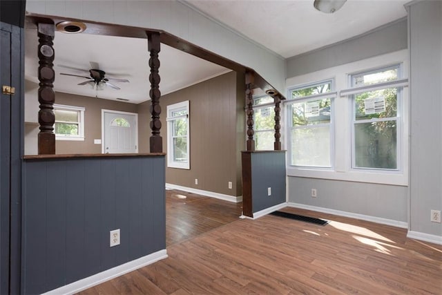 interior space with crown molding, dark wood-type flooring, and ceiling fan