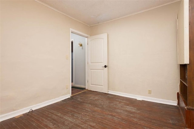 spare room featuring ornamental molding and wood-type flooring