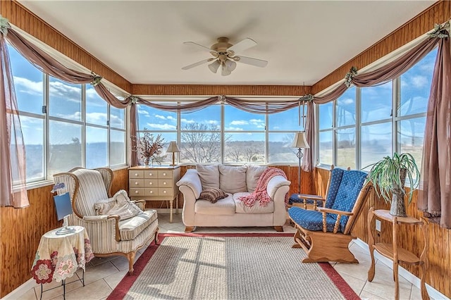 sunroom / solarium featuring a water view and ceiling fan