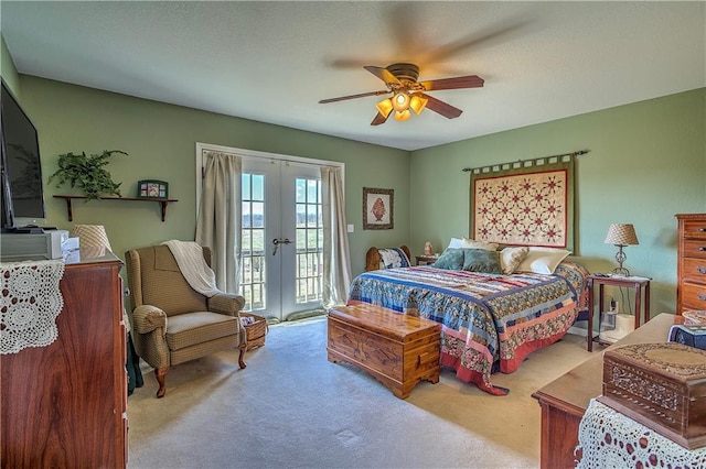 bedroom with ceiling fan, light colored carpet, access to exterior, and french doors