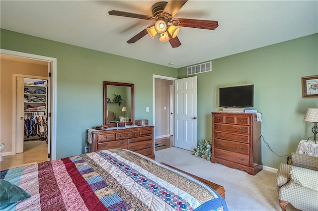 bedroom featuring a closet, ceiling fan, and light carpet