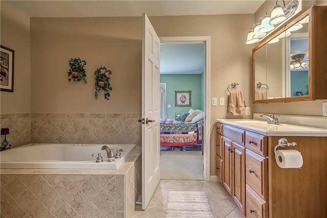 bathroom with tiled tub and vanity