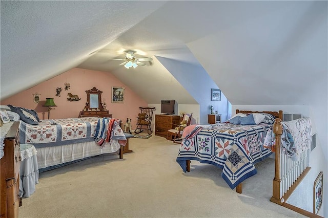 bedroom featuring ceiling fan, vaulted ceiling, a textured ceiling, and carpet floors