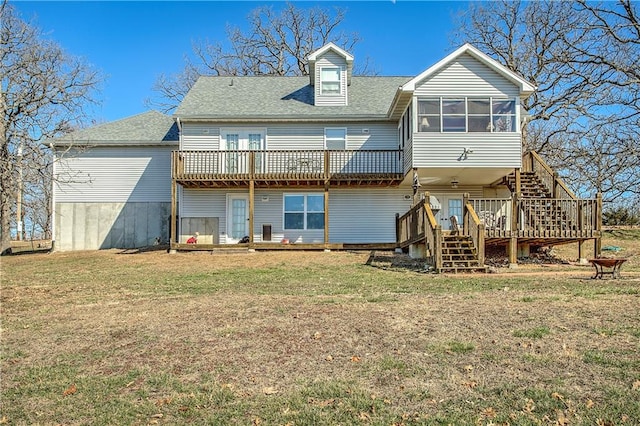 back of property with a storage shed, a wooden deck, a yard, and a sunroom