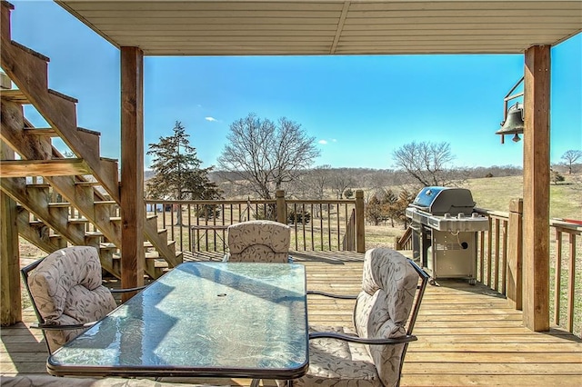 wooden deck featuring a grill