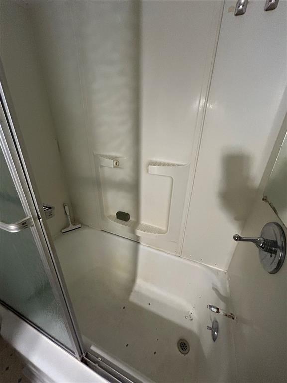 bathroom with shower / bath combination with glass door