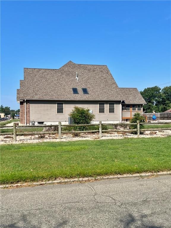 view of side of home with a yard