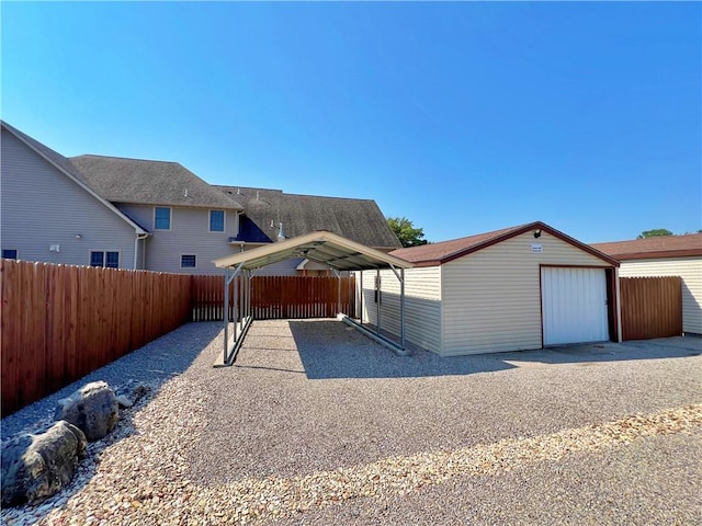 view of front of property with a carport, a garage, and an outdoor structure