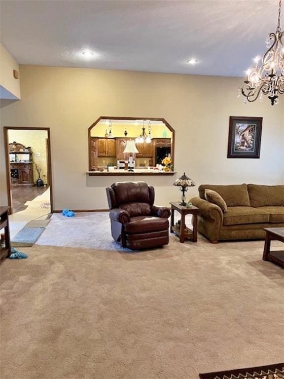 carpeted living room with a notable chandelier