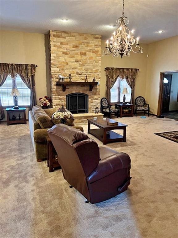 carpeted living room with a stone fireplace, plenty of natural light, and an inviting chandelier