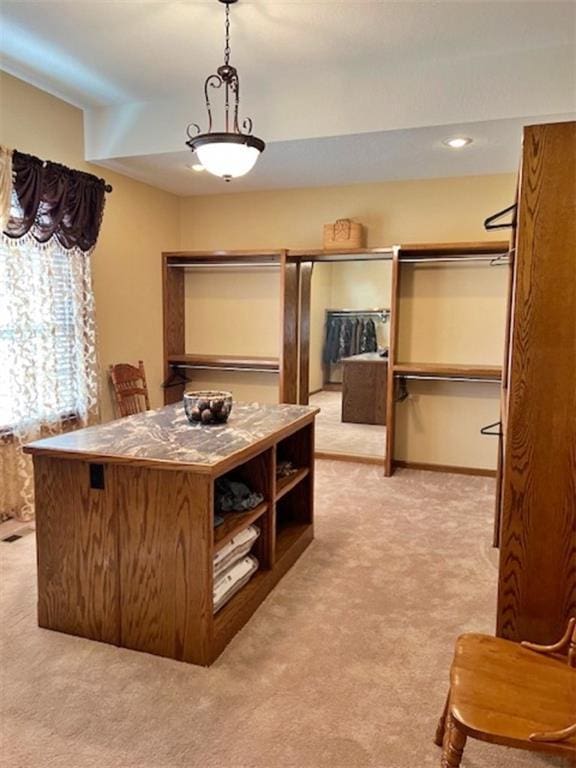 spacious closet with light colored carpet