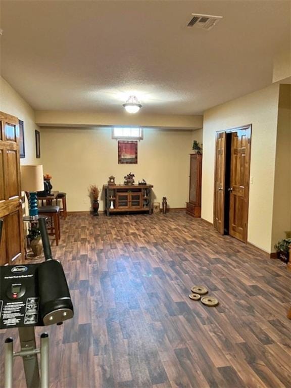 exercise room featuring dark wood-type flooring