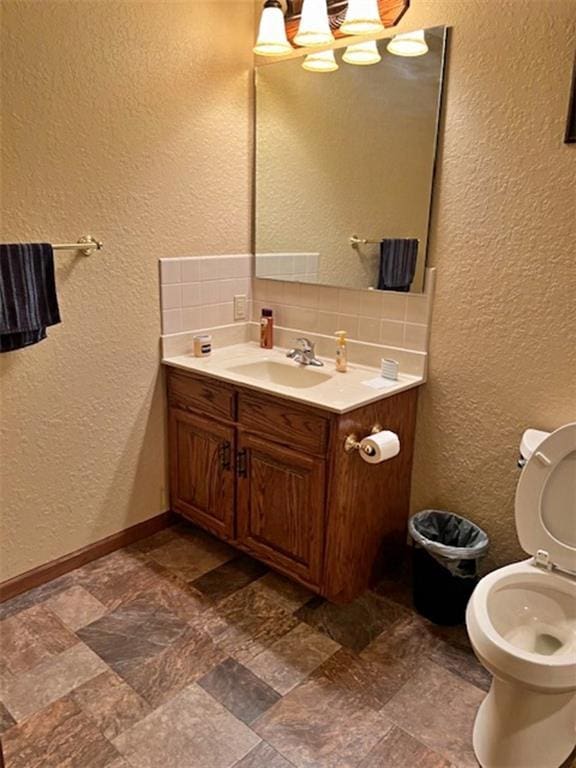 bathroom featuring decorative backsplash and vanity