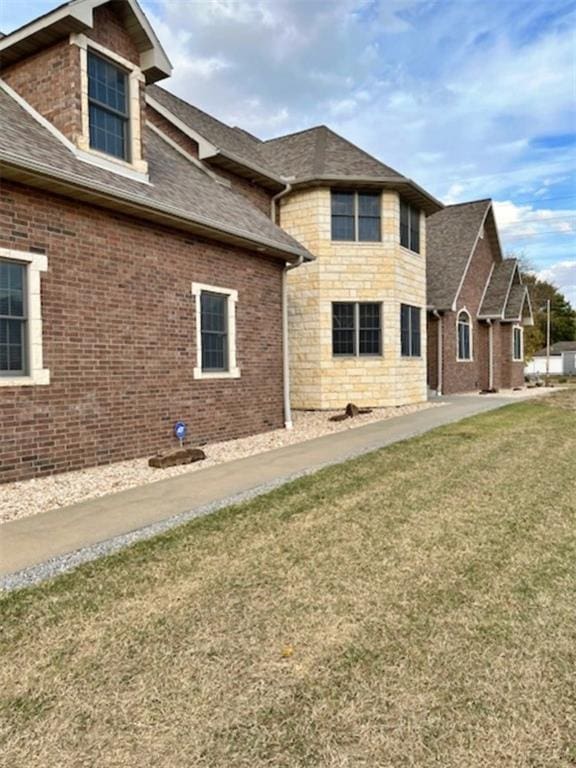 view of side of home featuring a yard