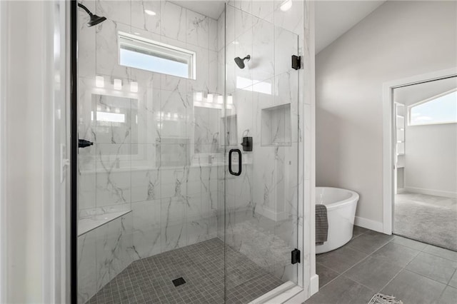 bathroom featuring tile patterned flooring and separate shower and tub