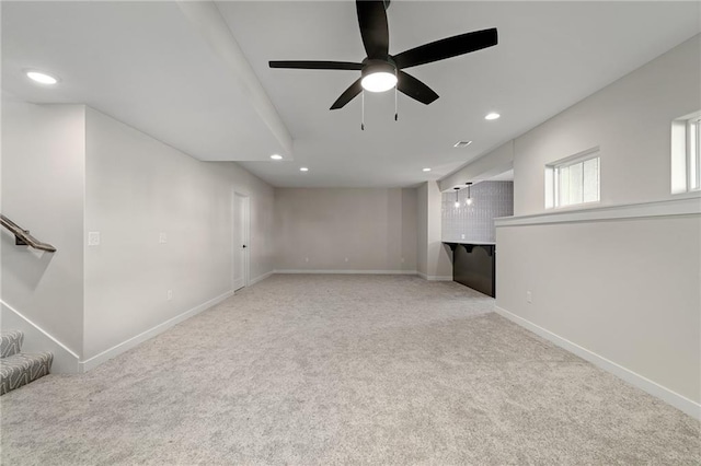 unfurnished living room with ceiling fan and light colored carpet