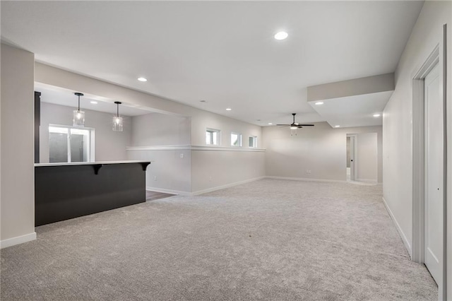 basement with light carpet and ceiling fan