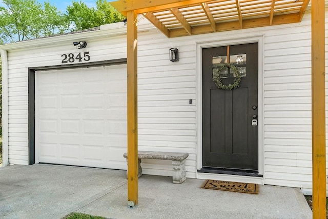 doorway to property featuring a garage