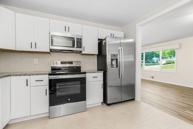 kitchen featuring backsplash, light wood-type flooring, white cabinetry, and stainless steel appliances