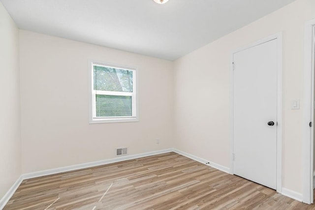 spare room with light hardwood / wood-style flooring