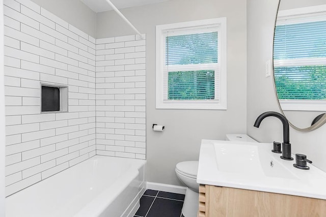 full bathroom featuring tile patterned floors, vanity, tiled shower / bath combo, and toilet