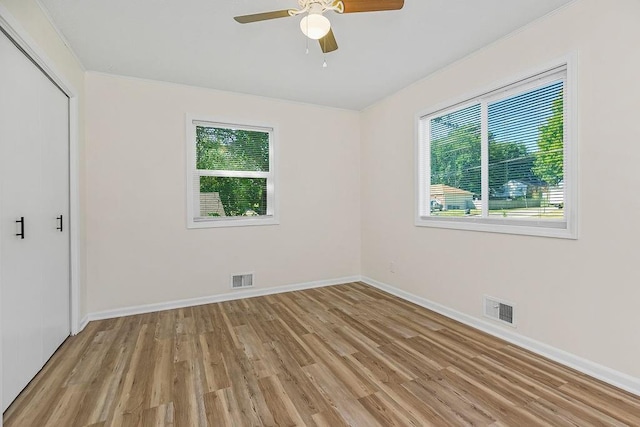 unfurnished bedroom featuring ceiling fan, light wood-type flooring, and a closet