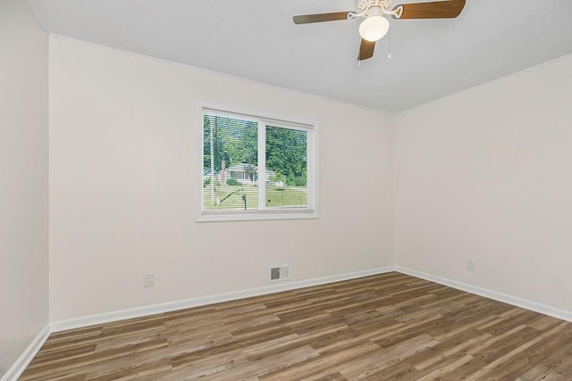 unfurnished room featuring hardwood / wood-style floors, ceiling fan, and ornamental molding