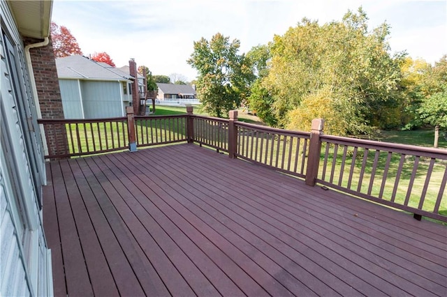 wooden terrace with a lawn