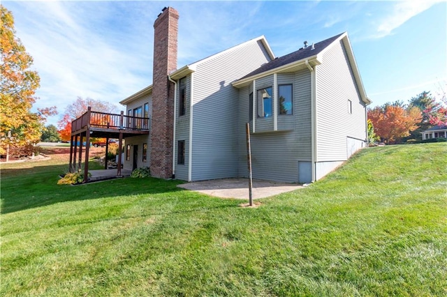 rear view of property with a patio area, a deck, and a yard