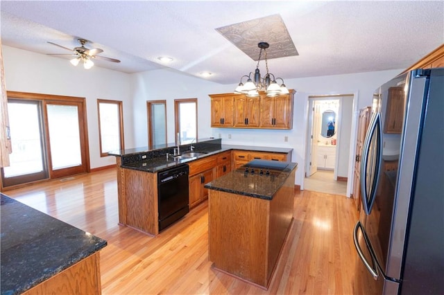 kitchen with a center island, a healthy amount of sunlight, dishwasher, and stainless steel fridge