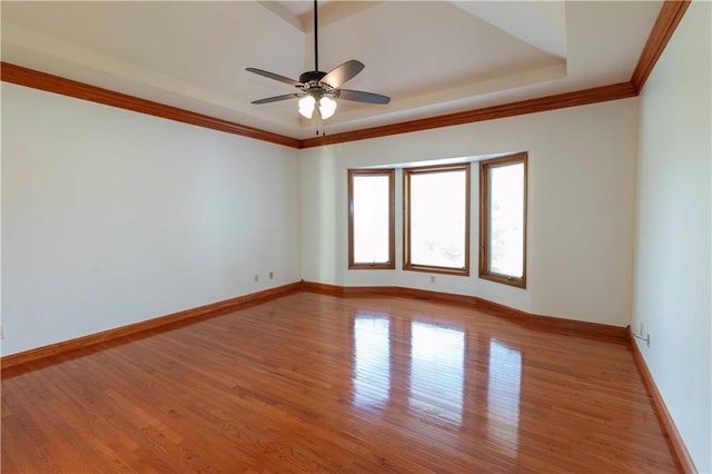 spare room with crown molding, light hardwood / wood-style floors, and ceiling fan