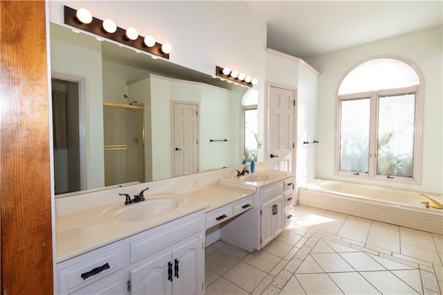 bathroom featuring vanity, a healthy amount of sunlight, tile patterned floors, and plus walk in shower