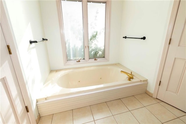 bathroom with tile patterned floors and a bath