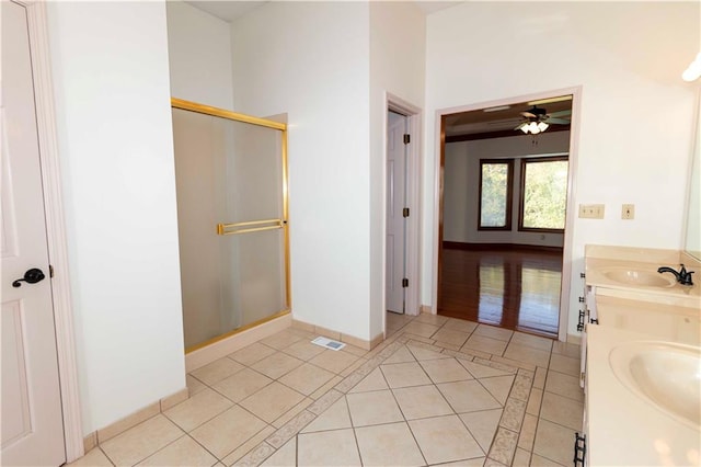 bathroom featuring vanity, a shower with shower door, tile patterned floors, and ceiling fan