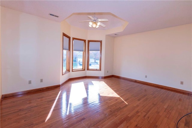 empty room featuring ceiling fan and hardwood / wood-style floors