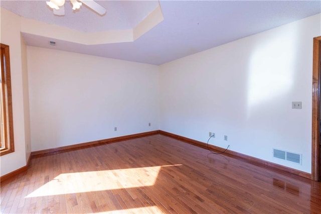 spare room featuring hardwood / wood-style floors and ceiling fan