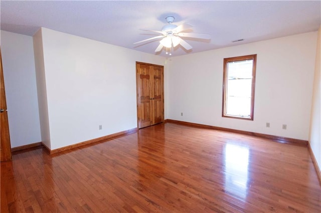 unfurnished room with hardwood / wood-style flooring and ceiling fan