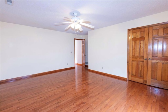 unfurnished room featuring hardwood / wood-style flooring and ceiling fan