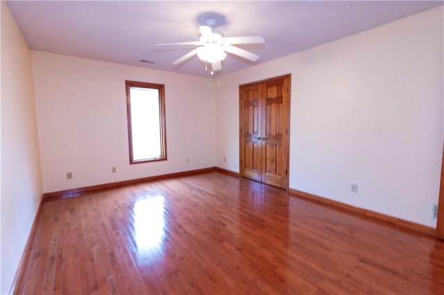 spare room with hardwood / wood-style floors and ceiling fan