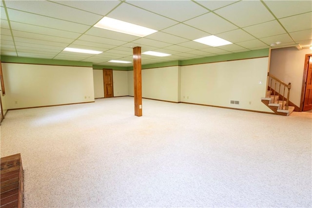 basement with carpet floors and a paneled ceiling