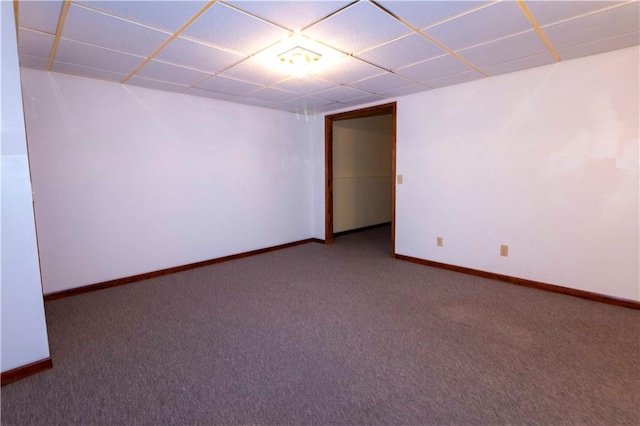 carpeted empty room with a drop ceiling