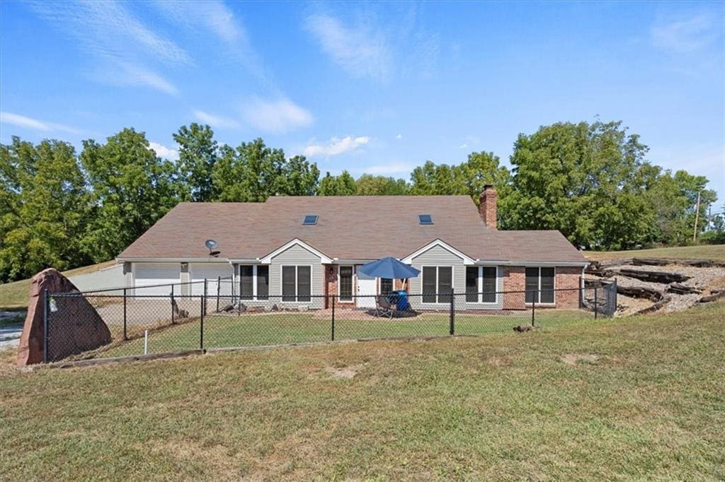 rear view of house with a yard