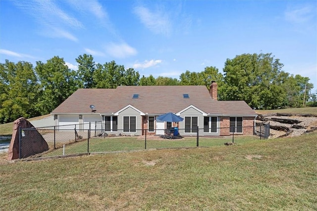 rear view of house with a yard