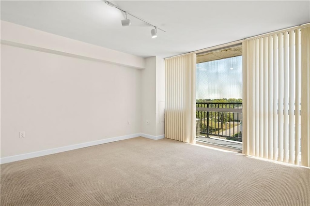 600 E Admiral Blvd Unit 704, Kansas City, MO 64106 - carpeted spare room with rail lighting and floor to ceiling windows