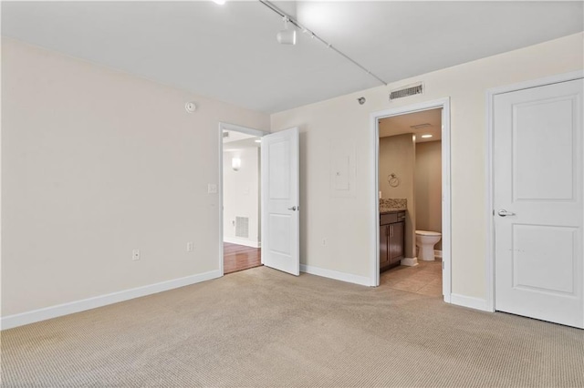 600 E Admiral Blvd Unit 704, Kansas City, MO 64106 - unfurnished bedroom with light carpet and ensuite bathroom