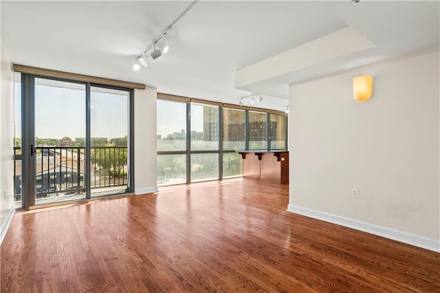 600 E Admiral Blvd Unit 704, Kansas City, MO 64106 - spare room with track lighting, wood finished floors, and a wall of windows