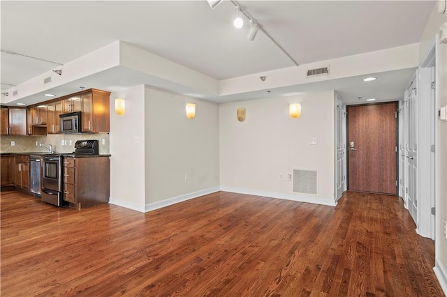 600 E Admiral Blvd Unit 704, Kansas City, MO 64106 - unfurnished living room with dark wood-type flooring, track lighting, and recessed lighting