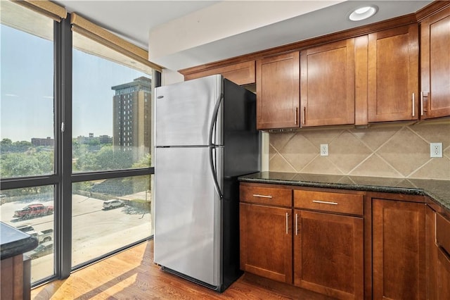 600 E Admiral Blvd Unit 704, Kansas City, MO 64106 - kitchen with freestanding refrigerator, tasteful backsplash, dark stone countertops, and recessed lighting