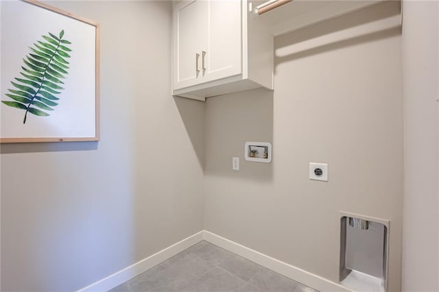 laundry room with hookup for a washing machine, cabinets, and electric dryer hookup